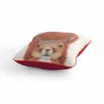 Squirrel cushion Call of the Wild with orange piping and hot pink back